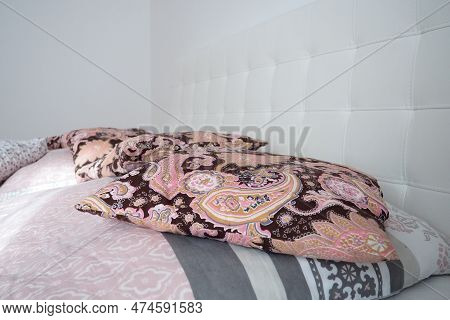 Pink Decorative Pillows On The Bed Linen. Double Bridal Bed With Pillows And Thick Feather Duvet. Be