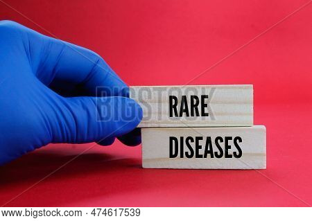 Hand Holding A Stick With The Word Rare Diseases. Medical Or Disease Concept