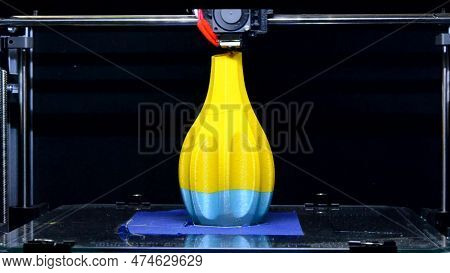 3d Printer. Work 3d Printer Close Up. 3d Printer Printing Vase Object Made Of Yellow-blue Plastic. P