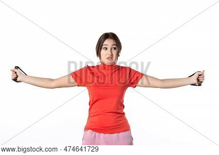 Front View Of A Busy Young Woman Neatly Gathering Her Hair Dressed In Redorange Blouse And Holding R