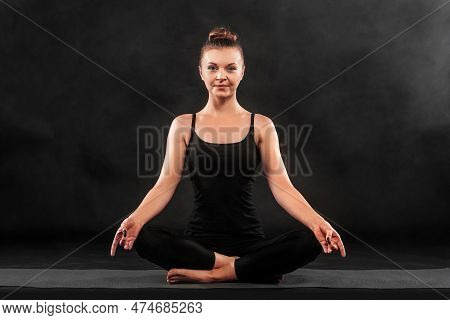 Acroyoga. Young Woman Practicing Acro Yoga On Mat In Studio. Hatha Yoga.