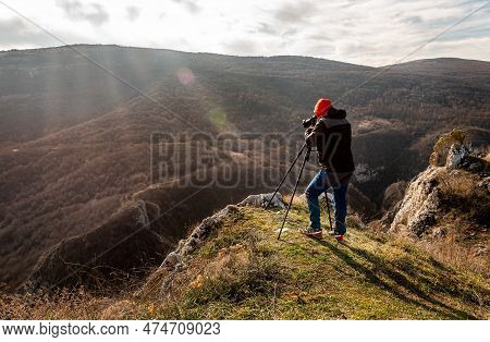 Photographer Taking Photographs With Digital Camera On A Tripod In Mountains. Travel And Active Life