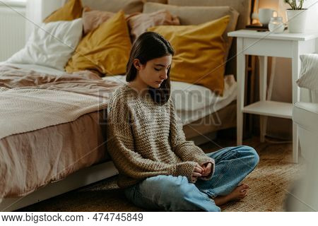 Unhappy Teenage Girl Sitting On The Floor, Koncept Of Mental Health.