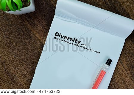 Concept Of Definition Diversity Verb Write On Book Isolated On Wooden Table.