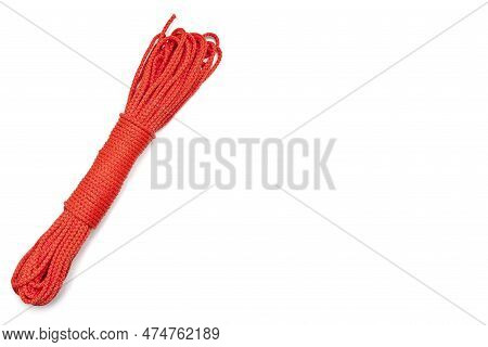 Bundle Of Neatly Twisted Red Nylon Rope On A White Background. The Red Rope Is Located Diagonally On