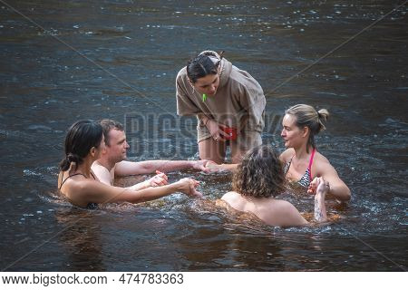 Vilnius, Lithuania - March 26 2023: Group Of People In Circle Ice Bathing Together In The Cold Water