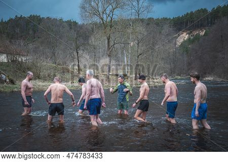 Vilnius, Lithuania - March 26 2023: Group Of Men In Circle Ice Bathing Together In The Cold Water Of