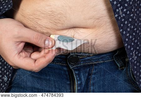A Modern Medical Patch For Prostatitis And Urinary Tract Infections. A Man Glues A Urological Patch
