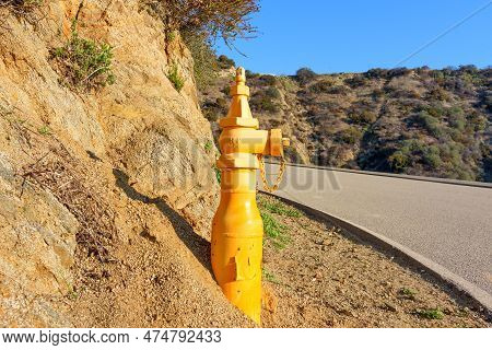 Close-up Of A Yellow Fire Hydrant Installed On The Roadside Of A Paved Fire Road In Runyon Canyon Pa
