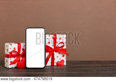Mobile Phone With Blank Screen On Colored Background With Hearts, Calendar And Gift Box, Valentine D