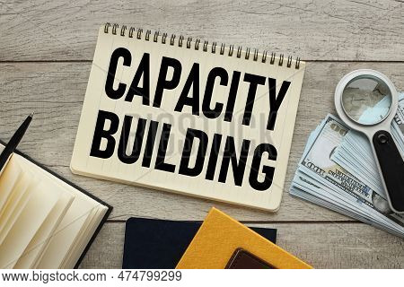Capacity Building . Business Concept. Open Notepad With Text Near Banknotes On The Table