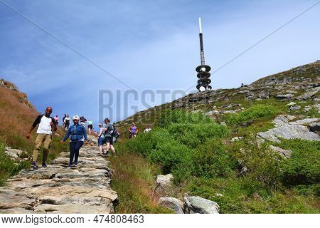 Bergen, Norway - July 23, 2020: People Hike To Ulriken Mountain Trail Overlooking City Of Bergen, No