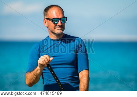 Man Riding Sup Stand Up Paddle On Vacation.