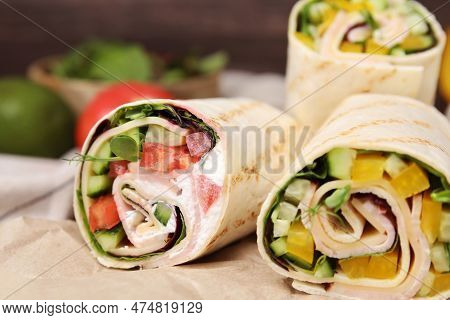 Delicious Sandwich Wraps With Fresh Vegetables On Parchment Paper, Closeup