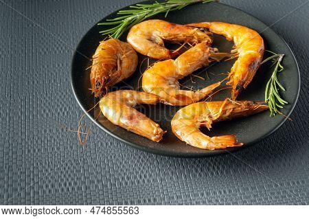 Caridea Or Boiled Shrimps With Rosemary In A Bowl On A Gray Table. The Idea Of Delicious Dietary Sea