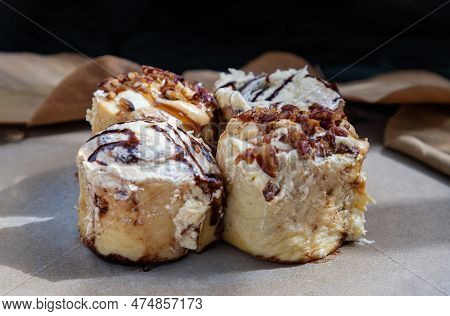 Close Up Of Two Soft Chocolate Buns Topped With Rich Cream Cheese Frosting And Two Caramel Pecanbon 