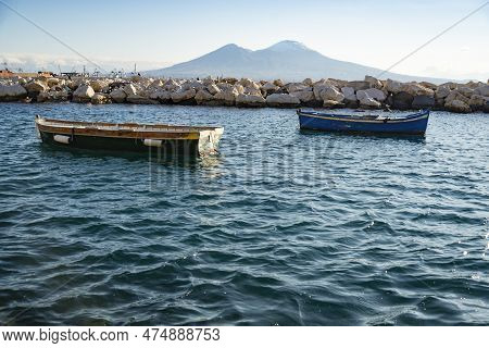 Vesuvius Seen And Fish Boats From The Seafront Of Naples, Italy
