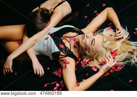 Top View Of Lesbians Couple, Holding Hands, Lying On Bed. Lesbian Couple In Bed.