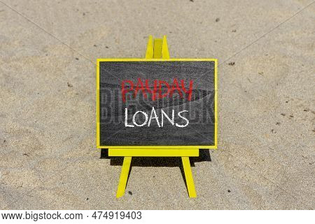 Payday Loans Symbol. Concept Words Payday Loans On Beautiful Black Chalk Blackboard On A Beautiful S