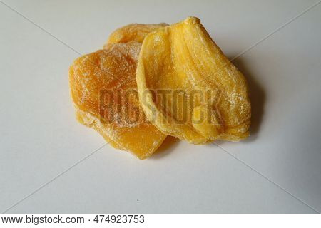 Macro Of Two Pieces Of Fleshy Yellow Dried Jack Fruit