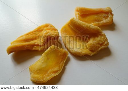 Close View Of Four Pieces Of Fleshy Yellow Dried Jack Fruit