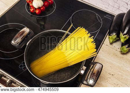 Female Hostess In The Kitchen Cooks Delicious Spaghetti