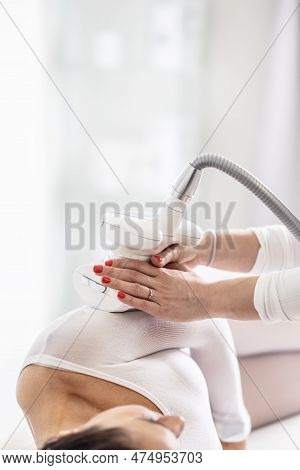 Woman In Beautification Studio Lies On Her Side While Cosmetician Slides Lpg Endermology Device Thro