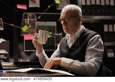 Elderly Investigator Analyzing Confidential Federal Files, Working Overhours At Criminal Investigati