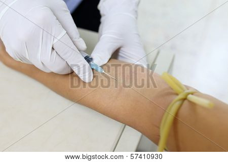 Nurse Taking Blood Sample From Patient At The Doctors Office