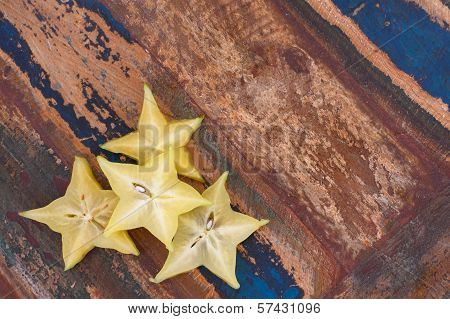 Slices Of Carambola Fruit On Wooden Table