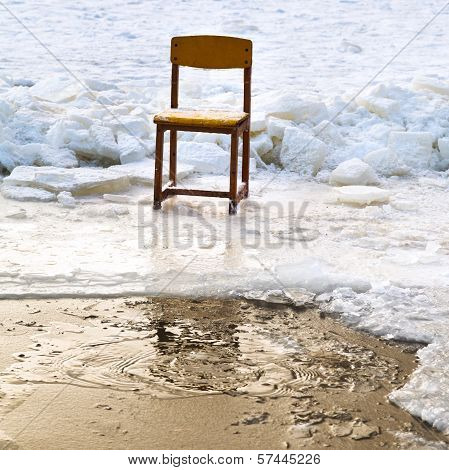 Icebound Chair On Edge Of Ice-hole In Frozen Lake