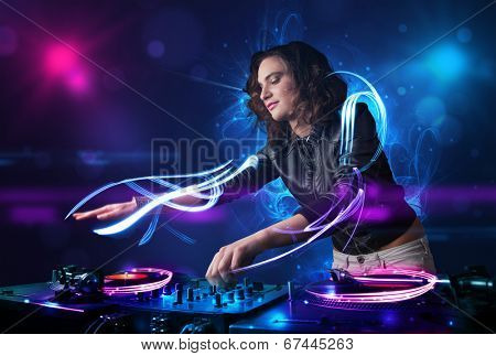 Beautiful disc jockey playing music with electro light effects and lights