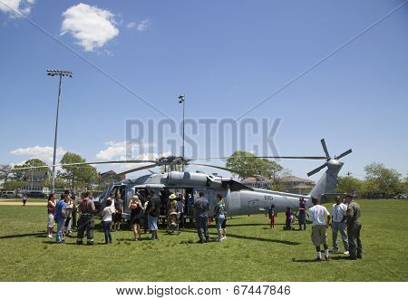 Numerous spectators around MH-60S helicopter from Helicopter Sea Combat Squadron Five during Fleet W