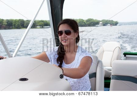 Teen Girl Driving A Boat