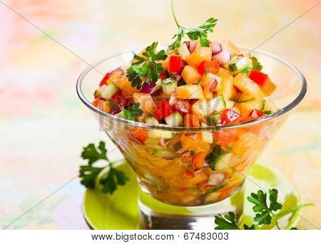 Fresh melon salsa with red pepper and cucumber