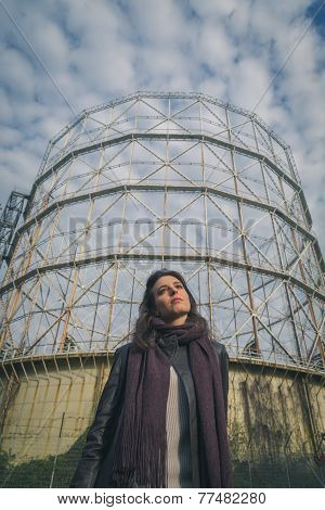 Beautiful Young Brunette Posing In Front Of A Gasometer
