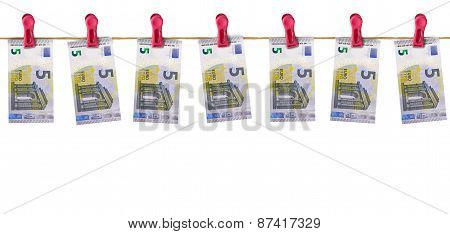 Euros bills hanging from a line.