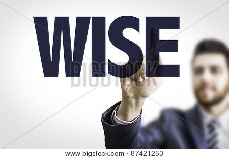 Business man pointing the text: Wise