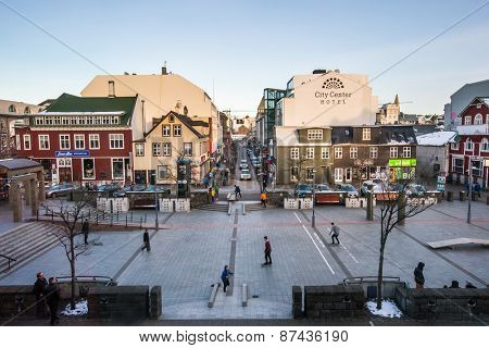 REYKJAVIK, ICELAND - MARCH 30, 2015: Young city dwellers ride on skateboards in the town center of Reykjavik on a winter evening, a lifestyle trend seen catching on in the young here. 