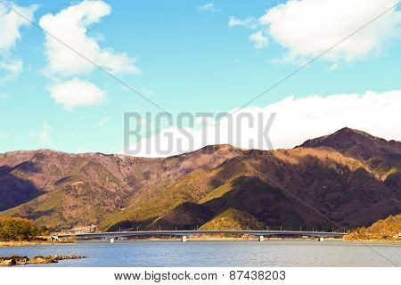 Bridge Of Lake Kawaguchiko With The Background Of Mountain And Blue Sky