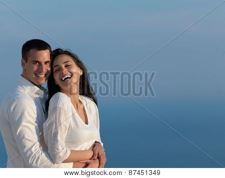 happy young romantic couple have fun relax smile at modern home outdoor terace balcony terace