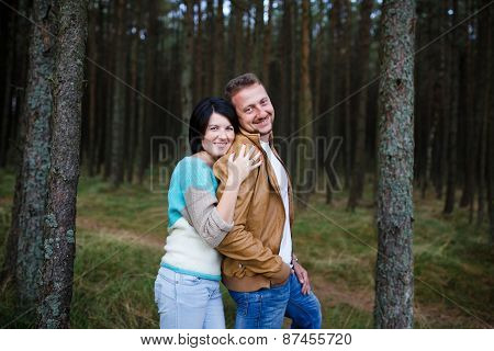 Happy Couple In A Pine Forest