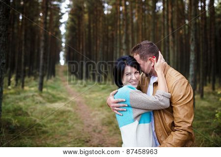 Happy Couple In A Pine Forest