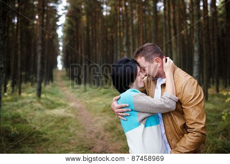 Happy Couple In A Pine Forest