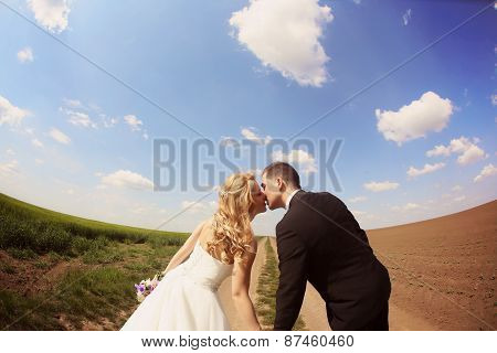 Bride And Groom Having Fun On The Fields