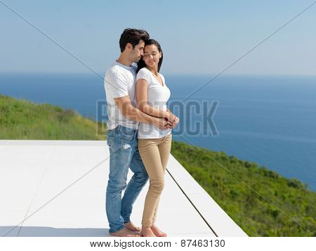 happy young romantic couple have fun relax smile at modern home outdoor terace balcony terace
