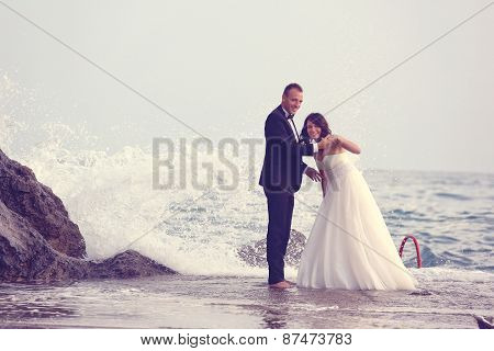 groom and bride near the sea