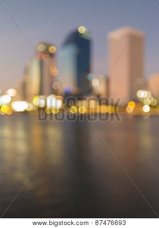 City light out of focus before sunset with water relfection