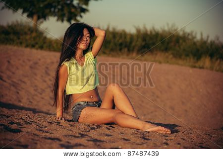 Woman sitting on the sand