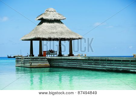 Boardwalk to arbor over blue ocean in Baros Maldives